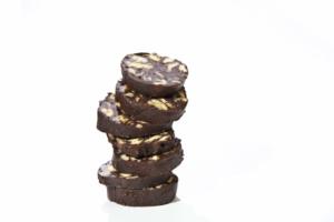 Stack of chocolate biscuit slices on white.