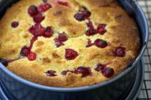 Golden berry-studded cake in round pan