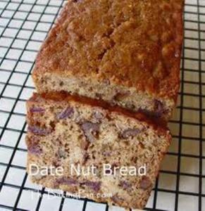 Moist date nut bread loaf on cooling rack