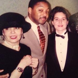 A man and two women posing for the camera.