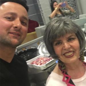 Smiling woman and man taking kitchen selfie