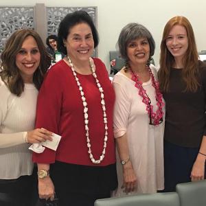 A group of women standing next to each other.