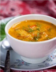 Bowl of vegetable soup with herbs.