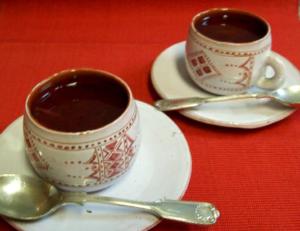 Two patterned cups of hot chocolate.