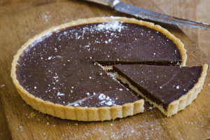 A chocolate pie is cut in half on the table.