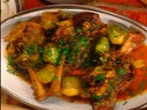 Cooked lamb with vegetables on a plate.