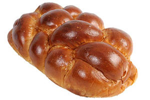 Braided bread loaf with glossy brown crust.