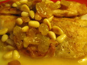 Chicken with raisins and pine nuts topping.