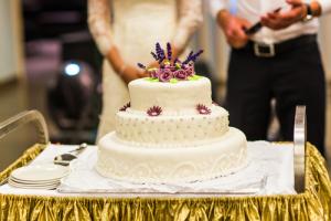 A bride and groom cutting their wedding cake.