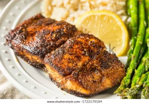 A plate of food with meat and lemon on it.