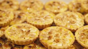 Glazed almond tartlets arranged on tray