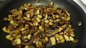Sauteed mushrooms and diced potatoes in skillet