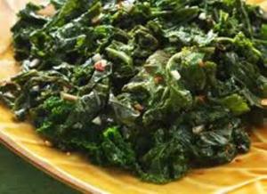 Cooked greens on a yellow plate.