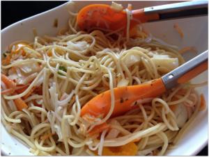 A close up of some noodles and carrots