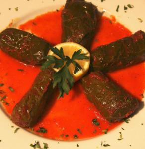 Stuffed grape leaves with sauce and lemon.