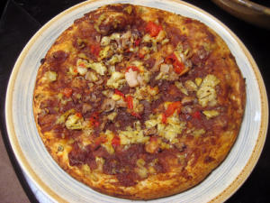 Pizza topped with vegetables and cheese.