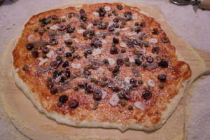 Homemade pizza with olives and cheese.