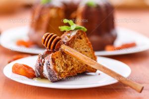 A piece of cake with honey on top.