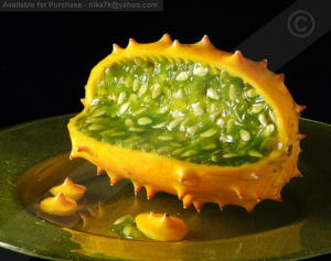 A close up of an open kiwano melon