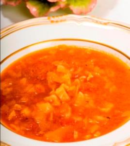 Bowl of hearty vegetable soup on plate.