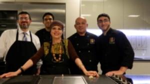 A group of people standing around a table.