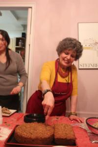 Two women in a kitchen preparing food.