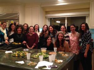 A group of people standing around a table.