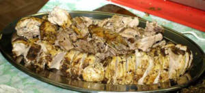Roasted meat slices on a serving platter.