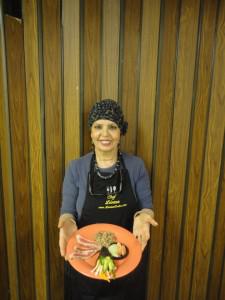 Woman holding a plate of food.