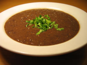 Bowl of black bean soup with cilantro.