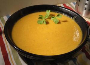 Bowl of creamy soup with cilantro garnish.