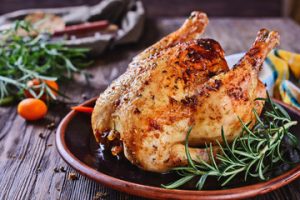 Whole golden roasted chicken with rosemary