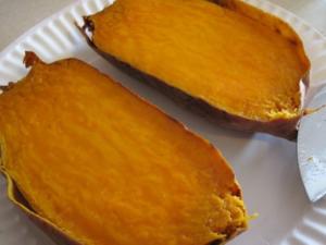 Baked sweet potato halves on white plate.