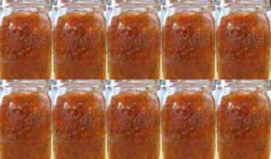 Eight jars of red-orange sauce aligned.