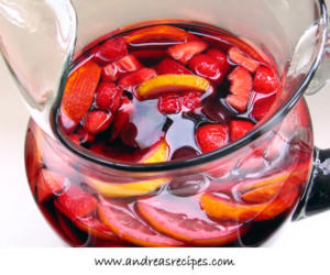 Pitcher of sangria with sliced fruit.