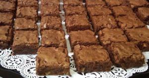 Chocolate brownies arranged on a decorative tray.