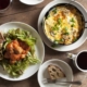A breakfast meal with an omelet, salad, toast, and coffee.
