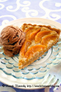 Peach tart with chocolate ice cream scoop.