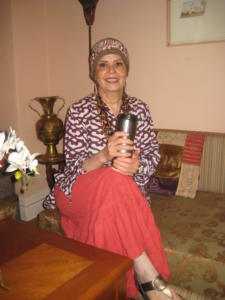 Woman sitting on couch holding a mug.
