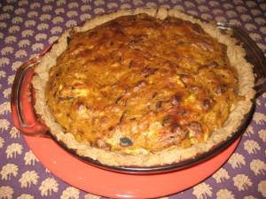 Homemade pie on patterned tablecloth.