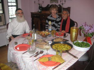 Three people dining at a festive table.
