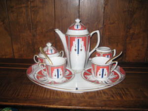 Art Deco porcelain tea set on shelf.