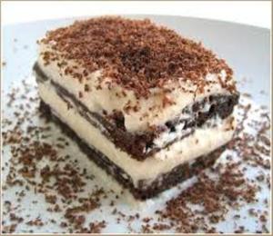 Layered chocolate and cream dessert on plate.