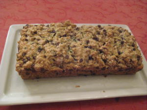 Chocolate chip zucchini bread on white platter.