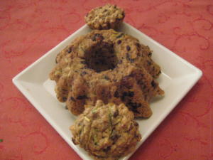 Bundt cake and muffins on white plate.