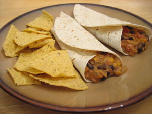 Tacos and tortilla chips on a plate.