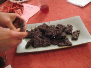 Plate of chocolate-covered treats on table.