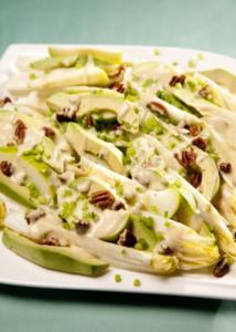 Salad with avocado, nuts, and creamy dressing.