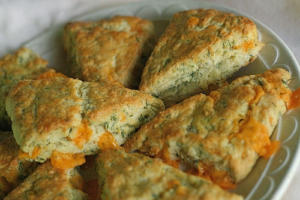 Cheddar scones with herbs on a plate.