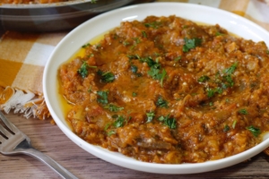 Hearty roasted eggplant dip garnished with parsley